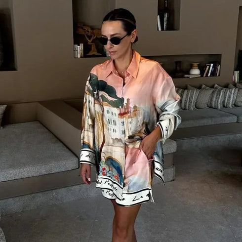 Woman wearing a colorful patterned shirt in a living room setting